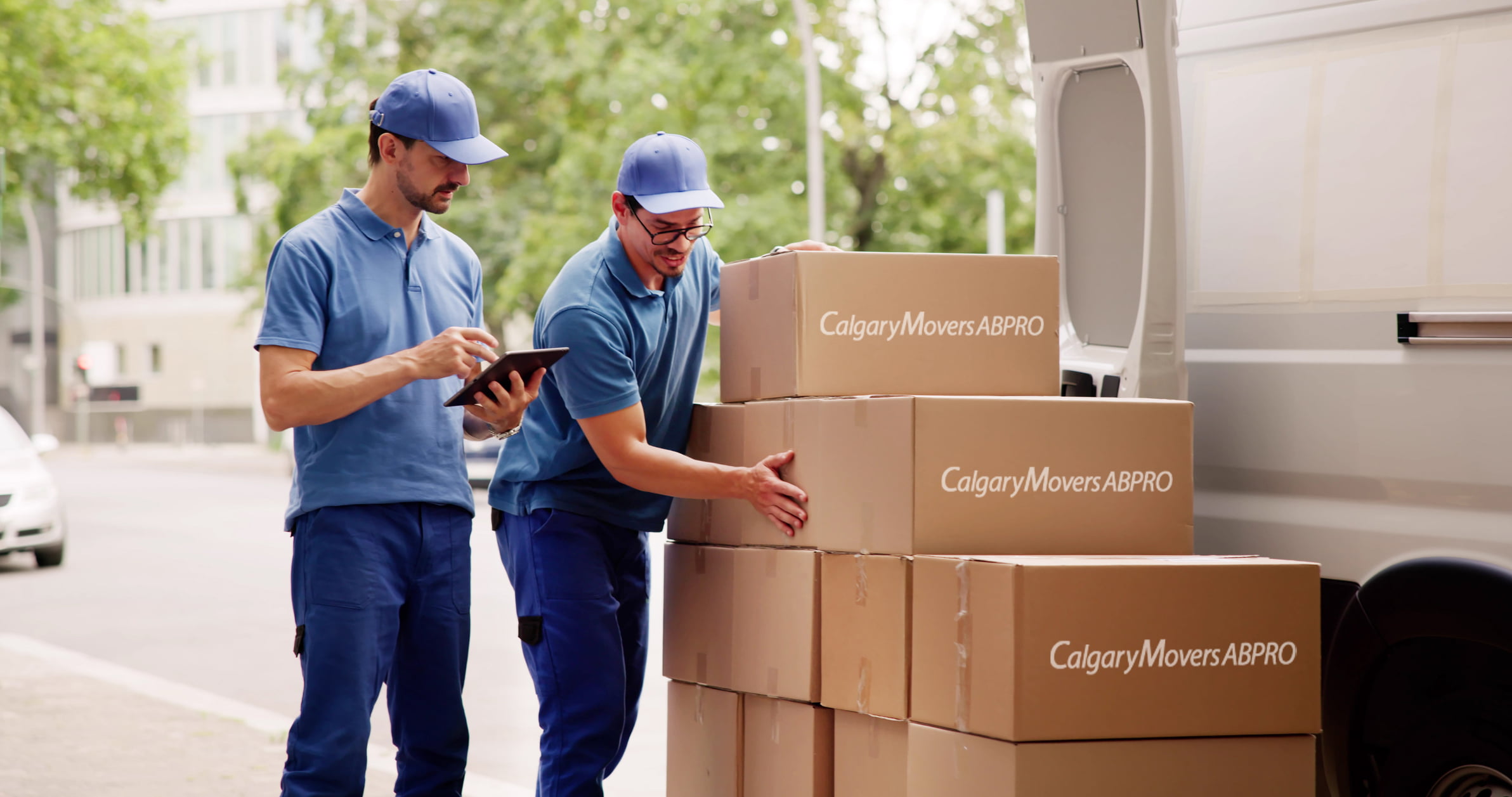 Professional movers from Calgary Movers ABPro loading packed boxes into a moving truck in Calgary