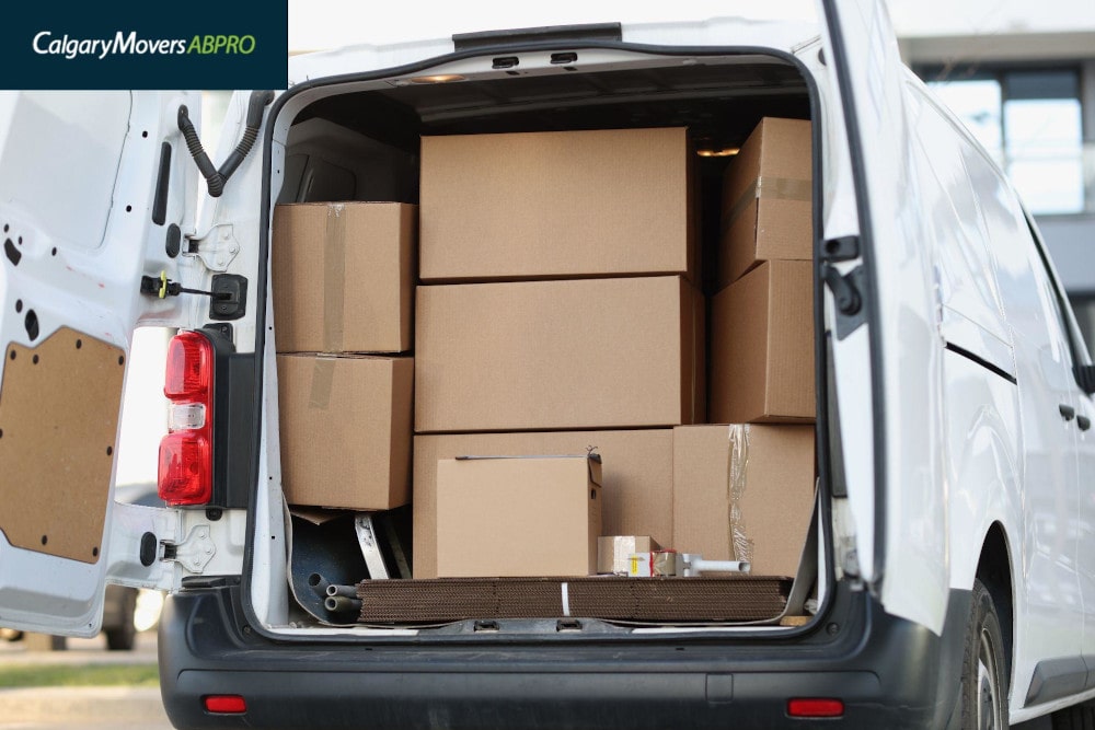 Open van loaded with cardboard boxes, ready for a moving day in Calgary, showcasing an organized and efficient relocation process