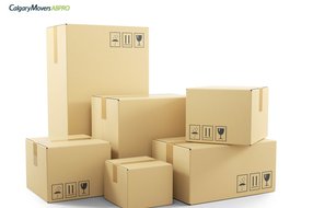 Stack of labeled cardboard boxes ready for a move, showcasing organized packing for a seamless relocation experience with Calgary Movers ABPro