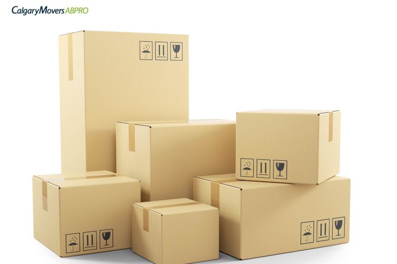Stack of labeled cardboard boxes ready for a move, showcasing organized packing for a seamless relocation experience with Calgary Movers ABPro